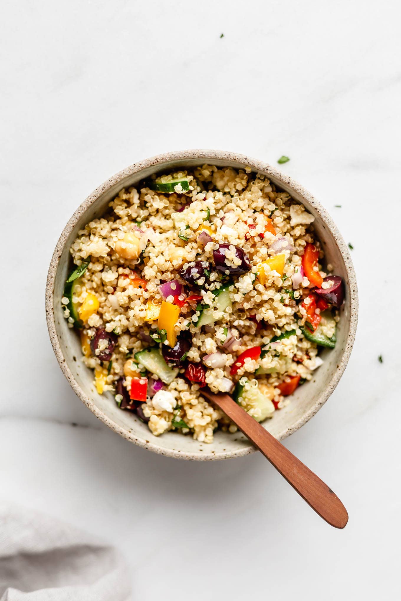 A bowl of mediterranean quinoa salad.
