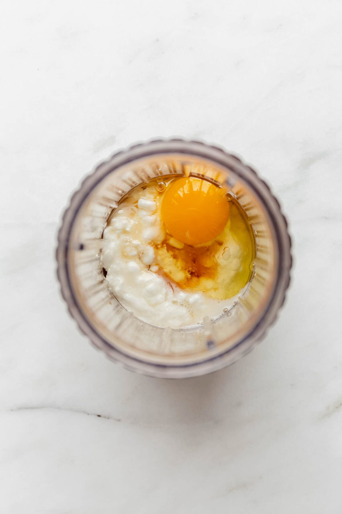 Egg, cottage cheese, oats and maple syrup in a blender container