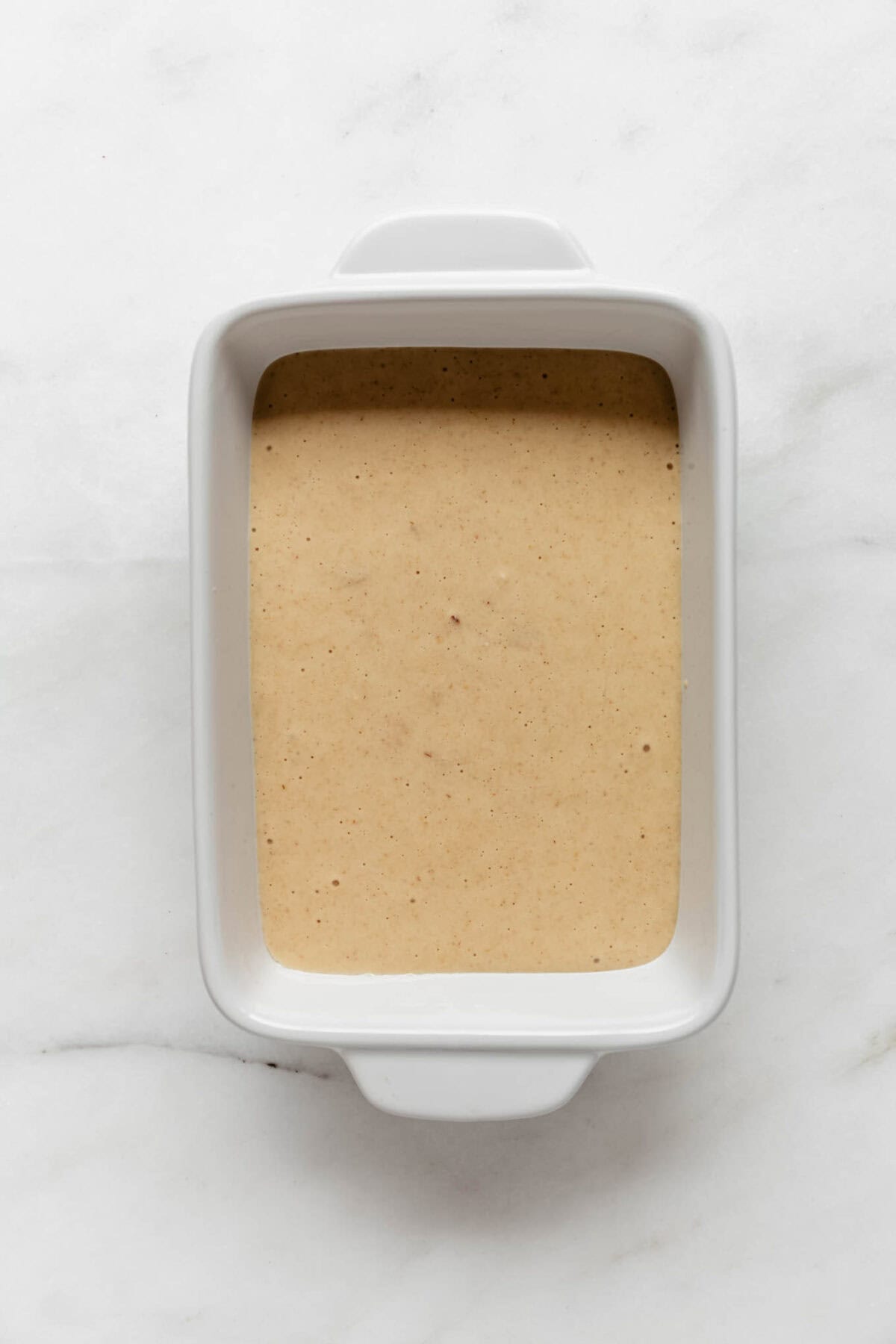 protein pancake bowl batter in a white baking dish.