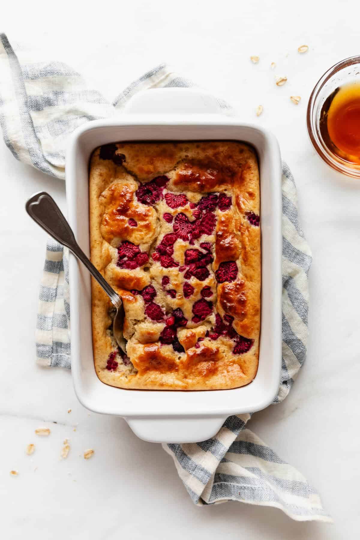 A protein pancake bowl in a baking dish on a blue stripe napkin