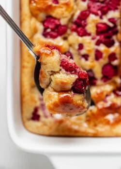 A spoonful of protein pancake bowl with raspberries.