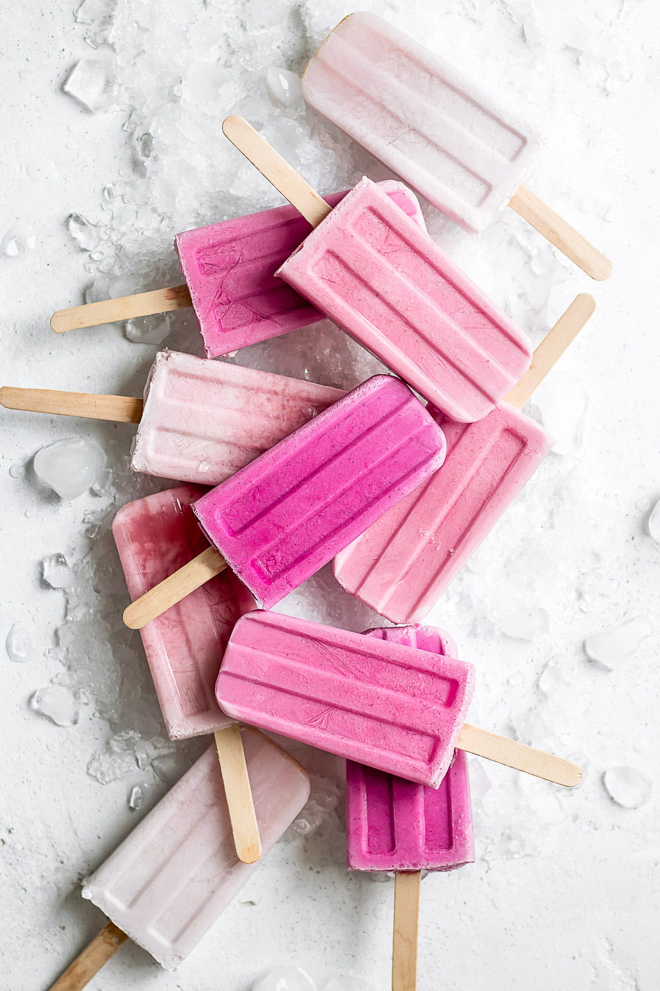 Ombre pink raspberry popsicles on ice.