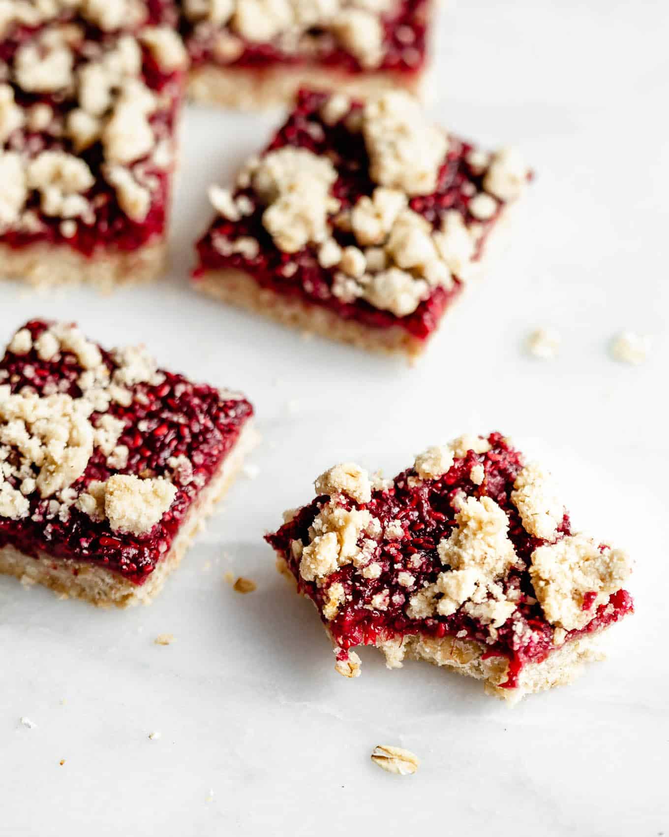 raspberry crumble bars on a marble board.