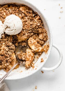 a silver spoon scooping up apple crisp.