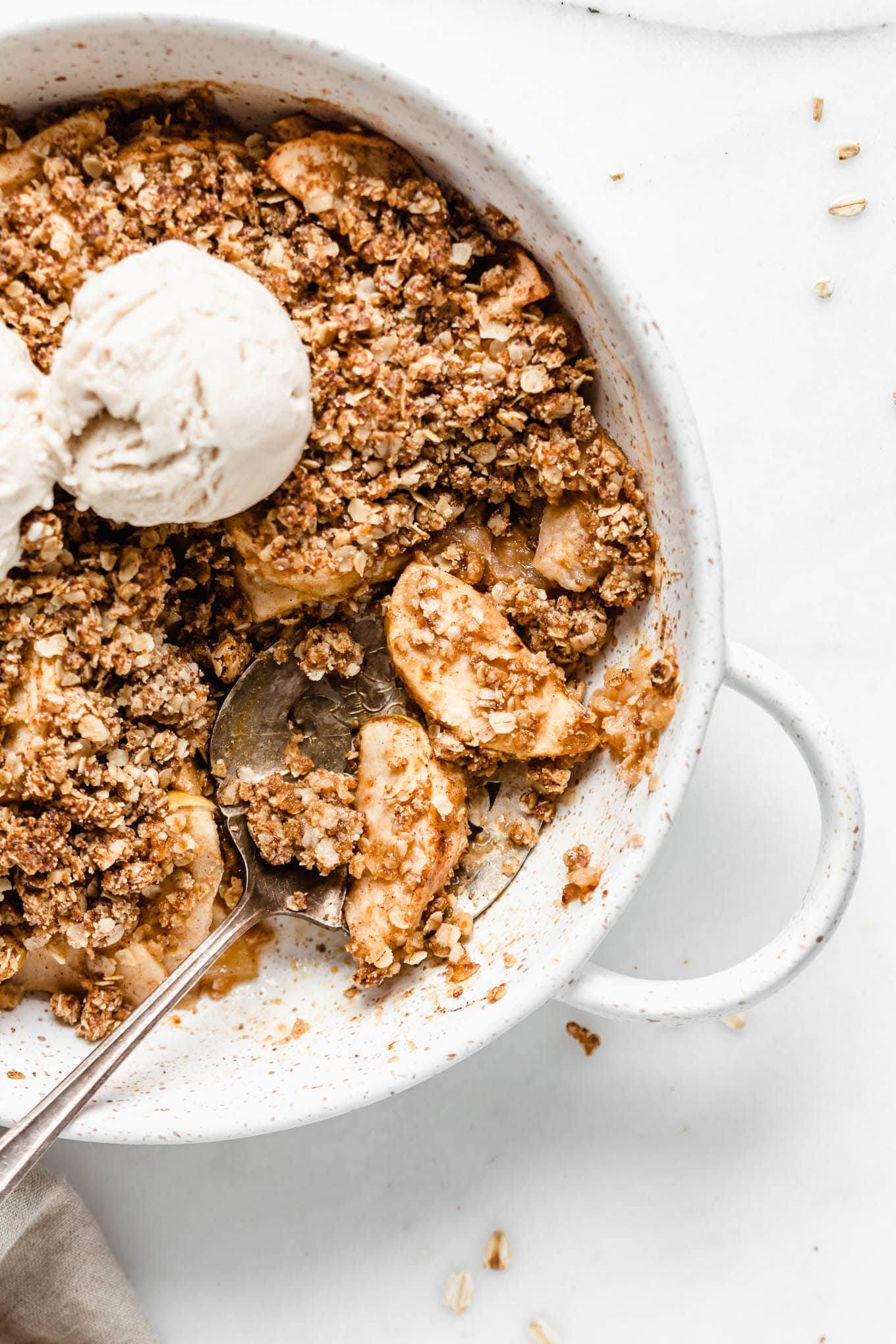 a silver spoon scooping up apple crisp.