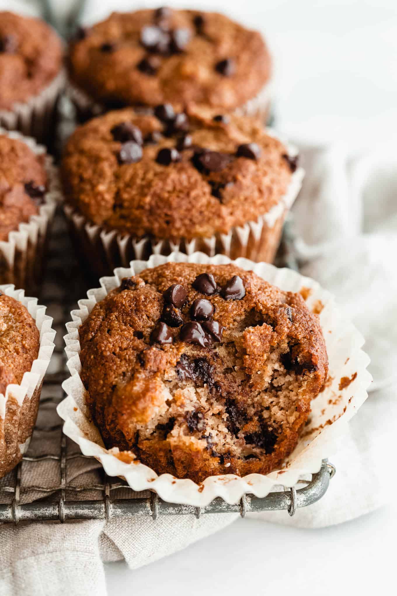 banana almond flour muffins with chocolate chips on a cooling rack.