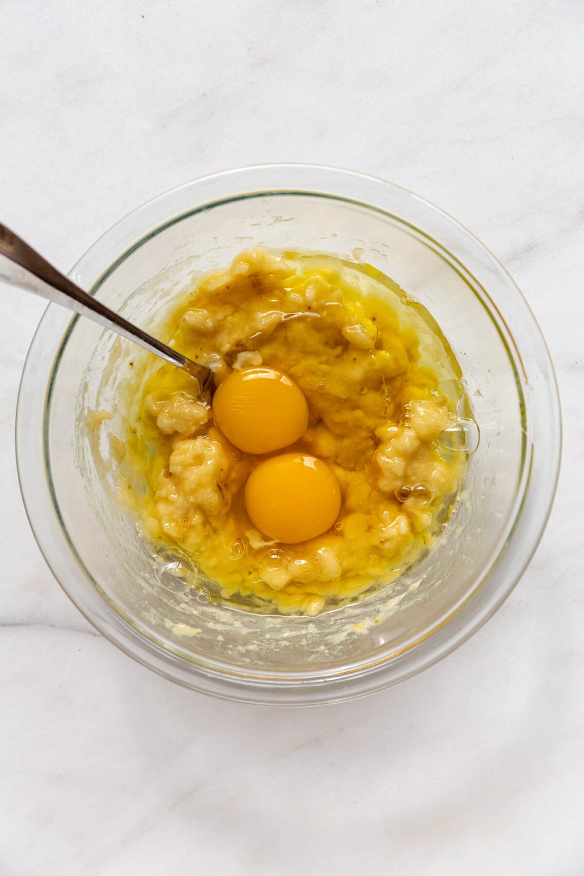 mashed banana and eggs in a bowl.