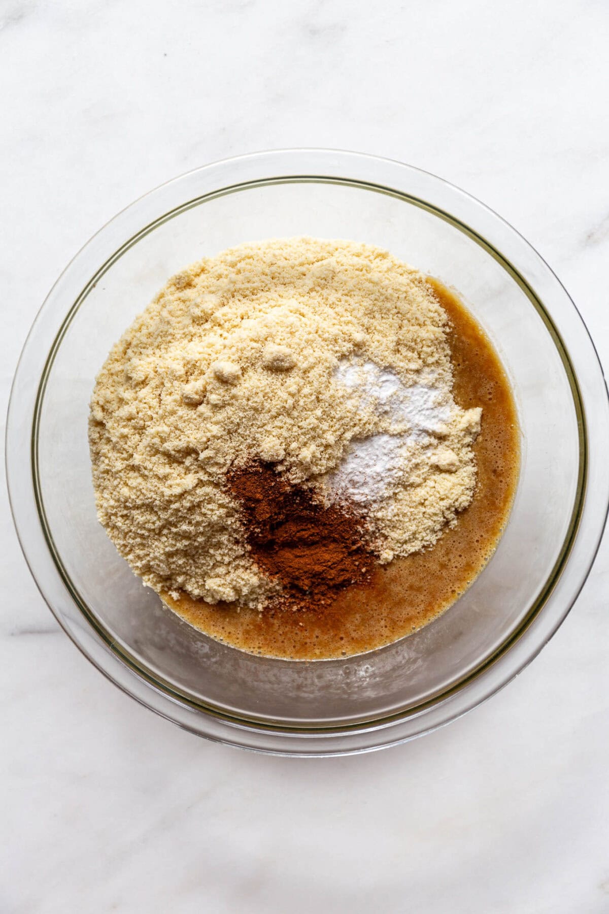 almond flour, spices, baking soda and whisked egg and banana in a bowl.