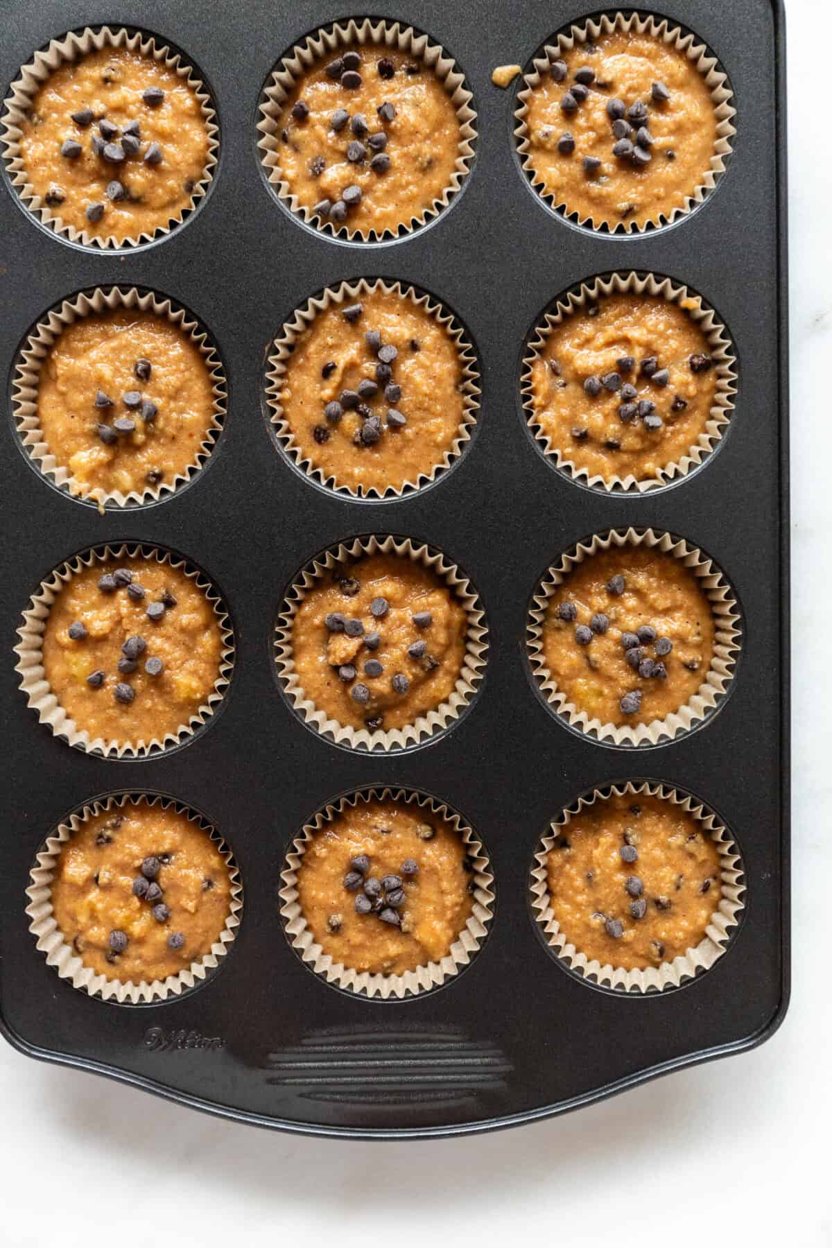 unbaked banana almond flour muffins in a muffin pan.