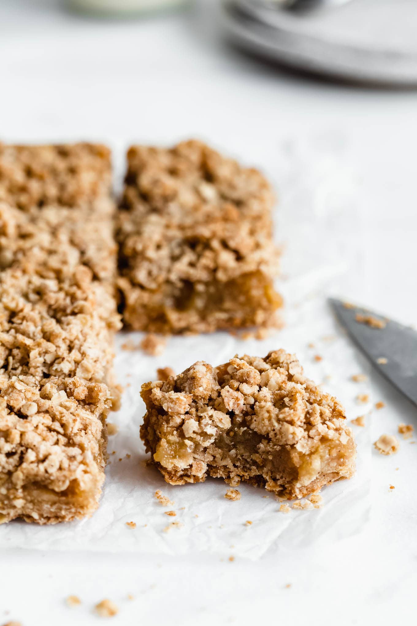 a sliced apple pie bar with a bite taken out of it.