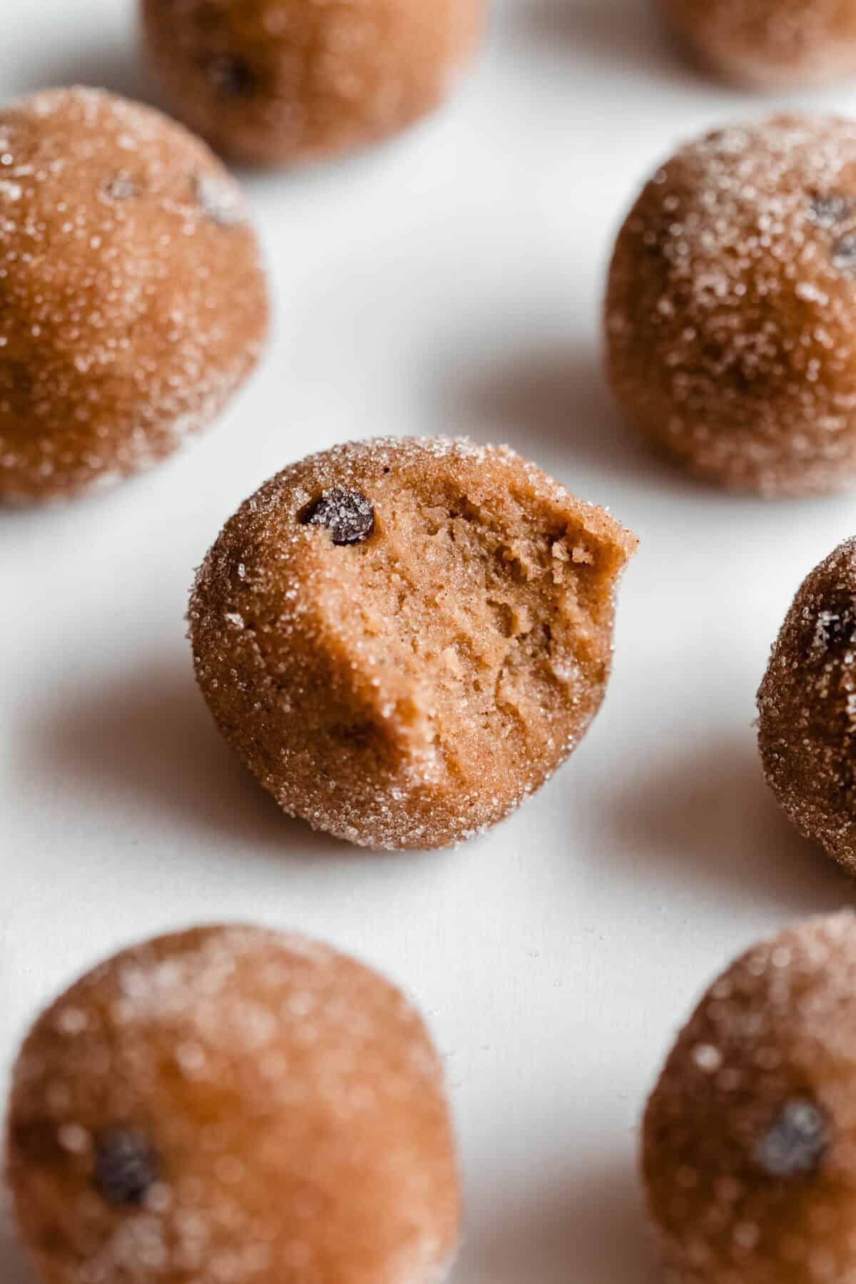 a banana protein ball with a bite taken out of it.