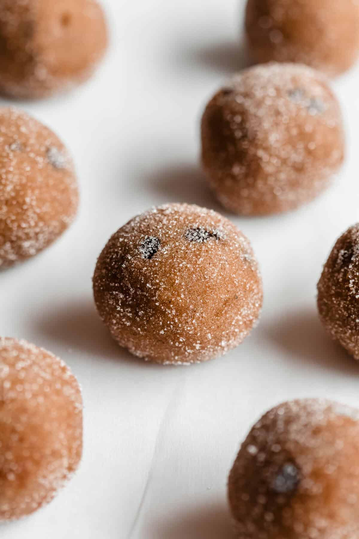 banana protein balls coated in sugar on parchment paper.