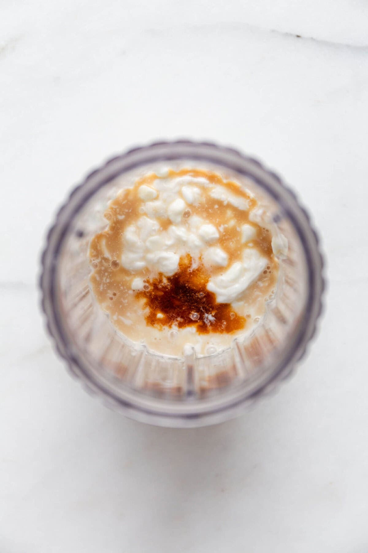cottage cheese, coconut milk and vanilla in a blender container.