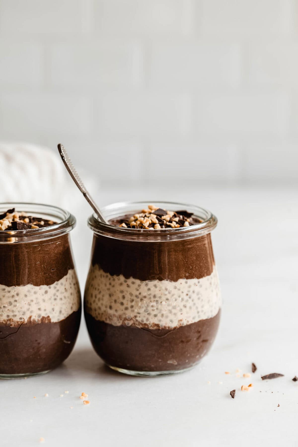 two cups of layered chocolate and peanut butter chia pudding.