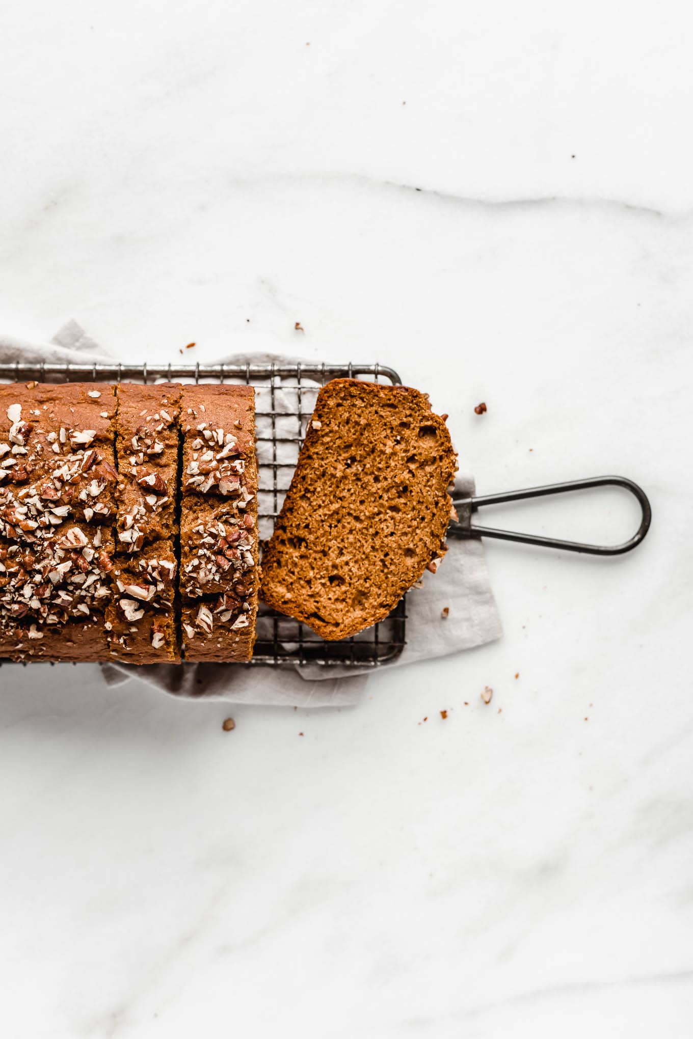 healthy maple pecan bread on a cooling rack.