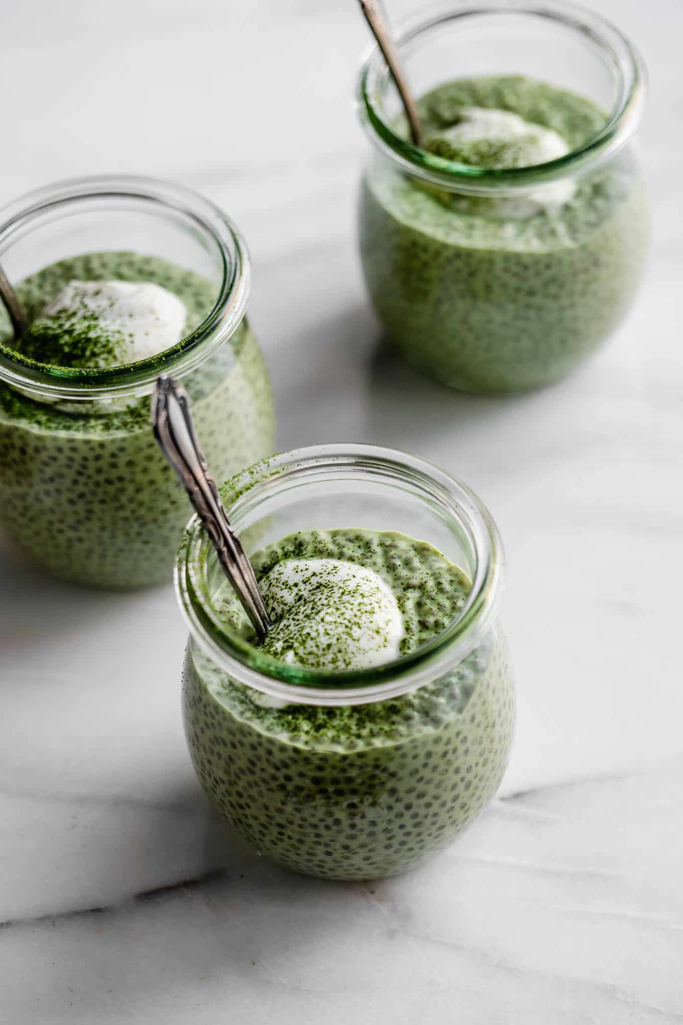 three small jars of matcha chia pudding.