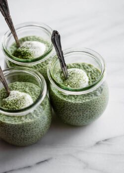 thee jars of matcha chia pudding topped with yogurt.