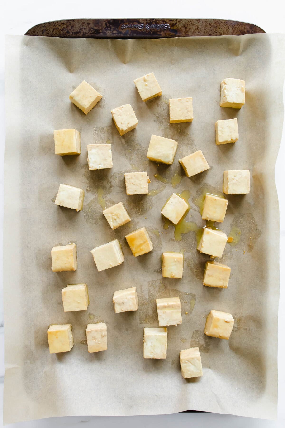 cubes of tofu on a baking sheet.