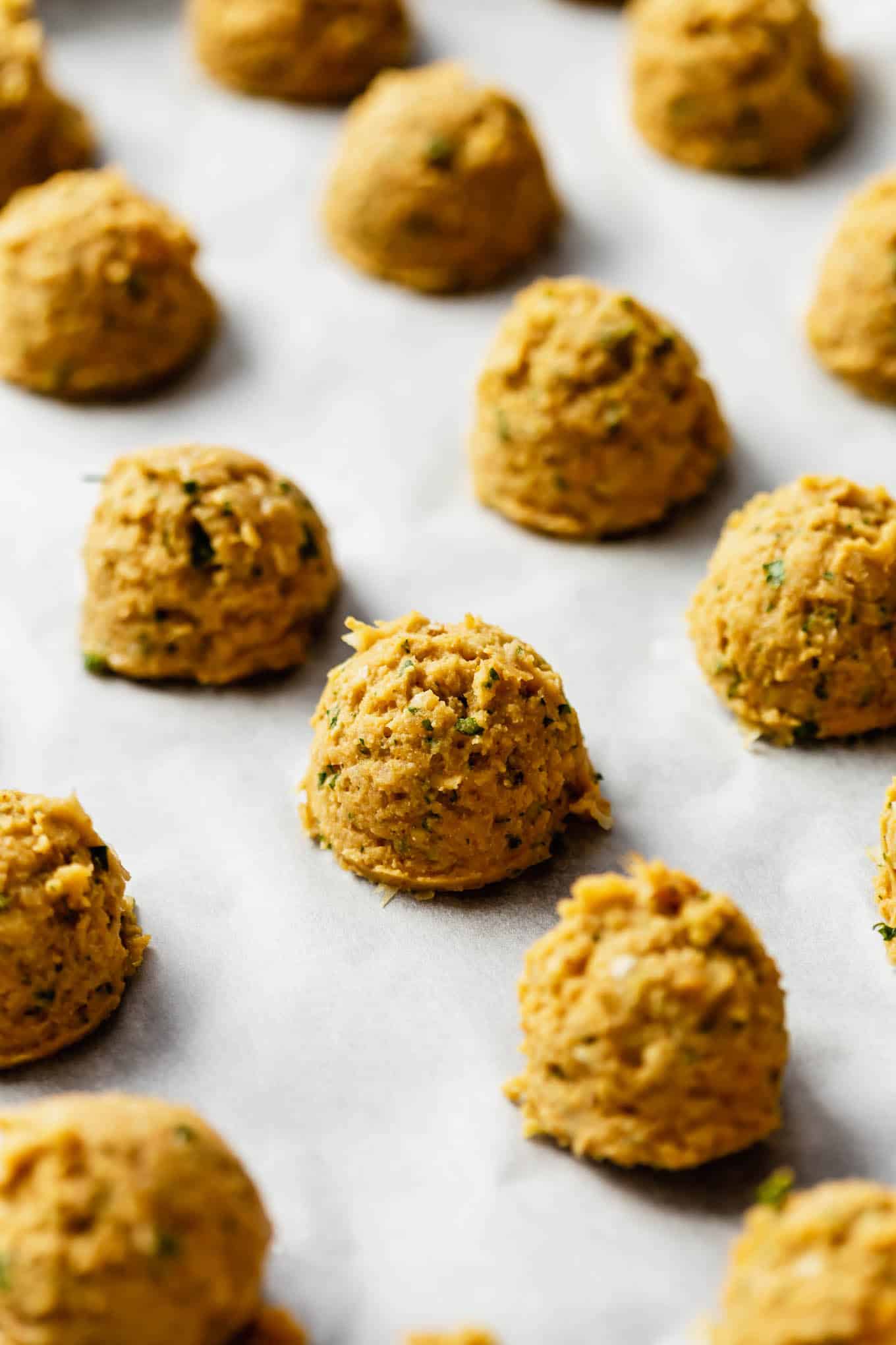 unbaked sweet potato falafel on parchment paper.