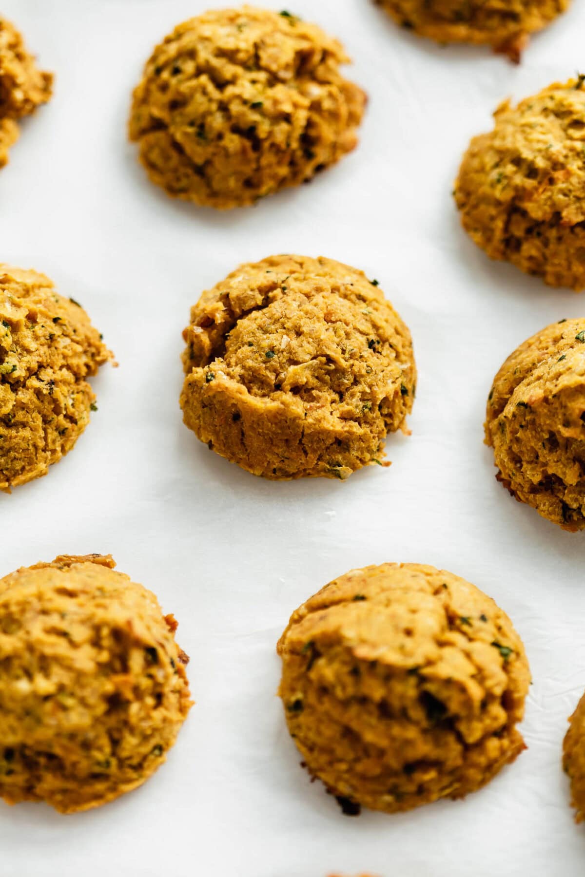 Baked sweet potato falafel on parchment paper.