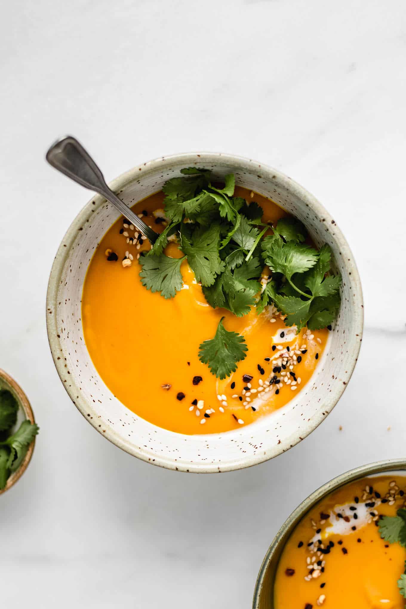 a bowl of Thai butternut squash soup topped with cilantro.