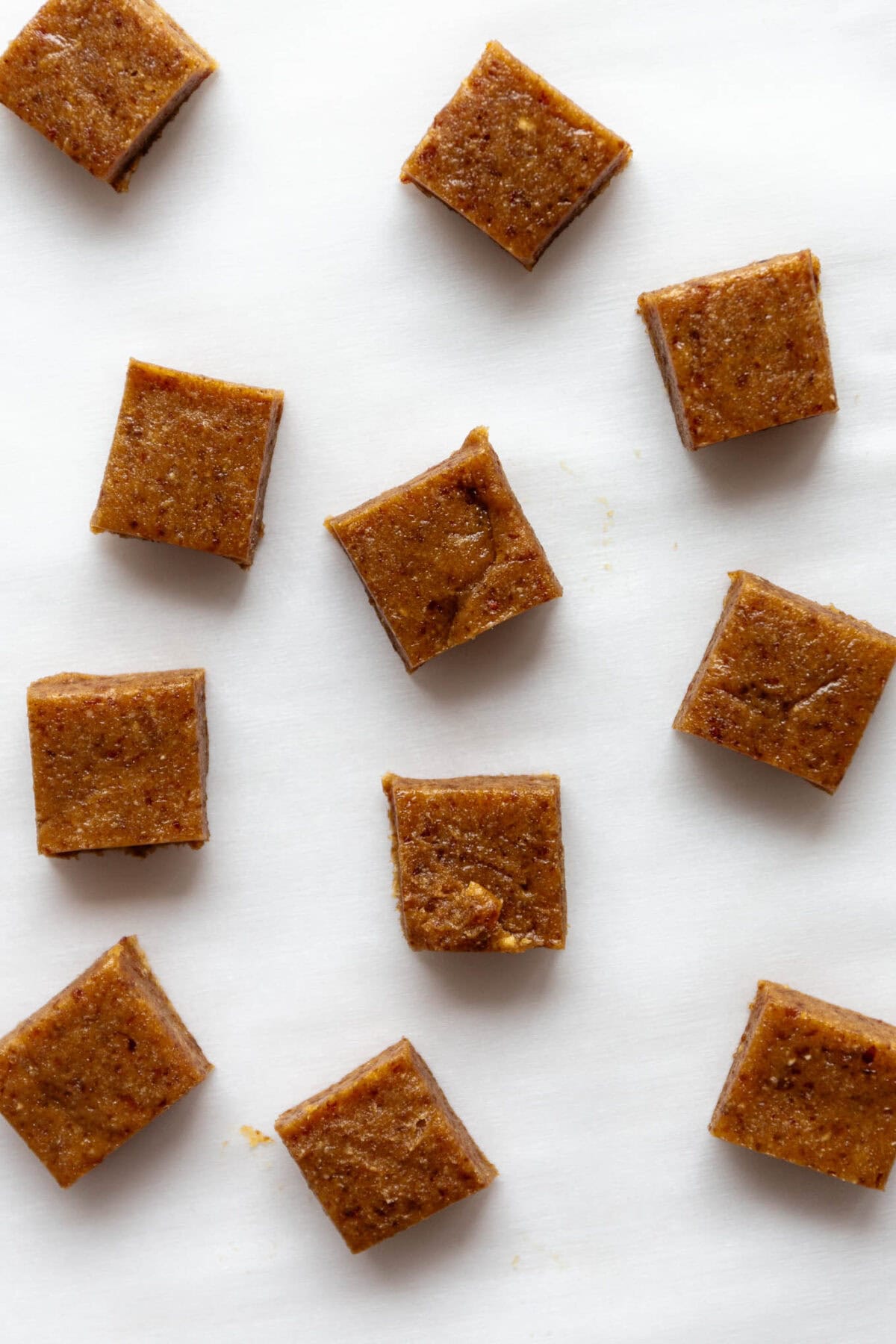 squares of date caramel on parchment paper.