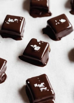 Date caramels dipped in melted dark chocolate topped with salt.