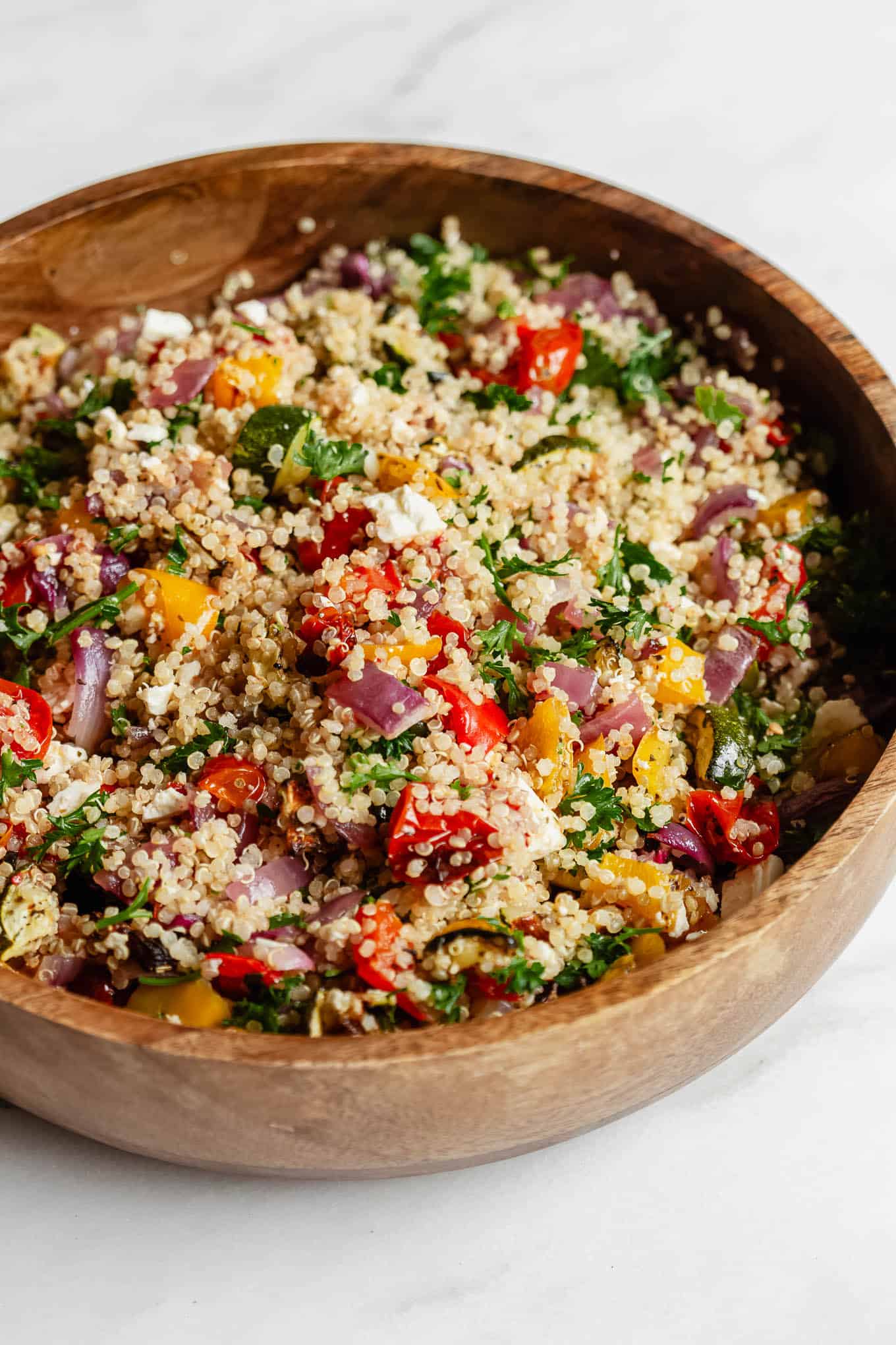 roasted vegetable quinoa salad in a wood bowl.
